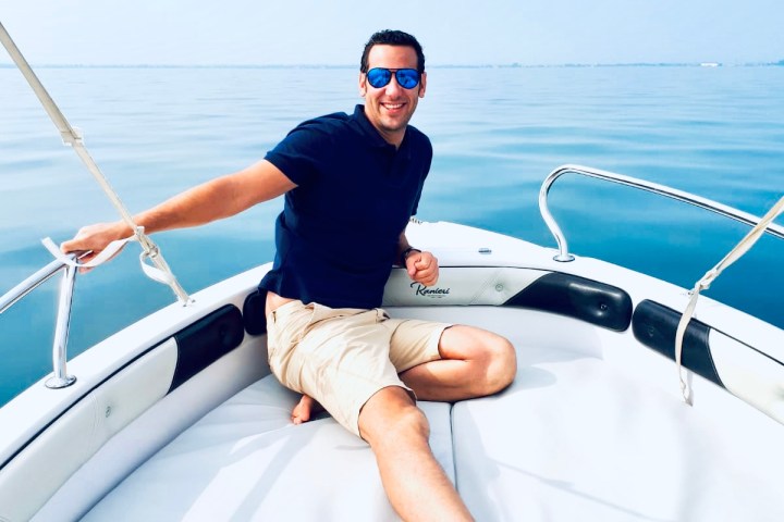 a man sitting in a boat on a body of water