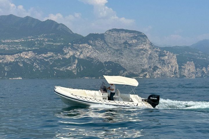 a small boat in a body of water with a mountain in the background